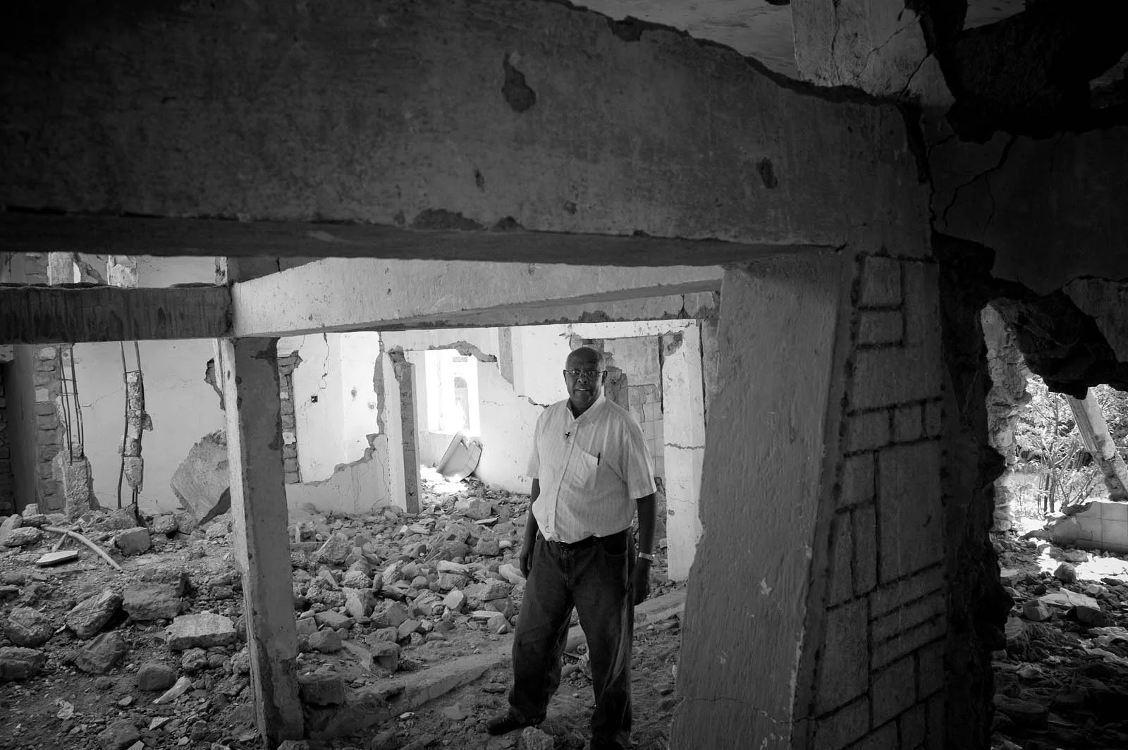 A returnee stands in the ruins of a bombed building in Hargeisa.